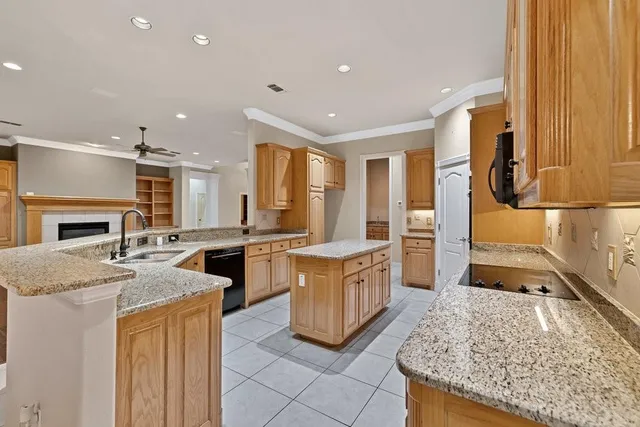 a kitchen with stainless steel appliances granite countertop a stove and more cabinets