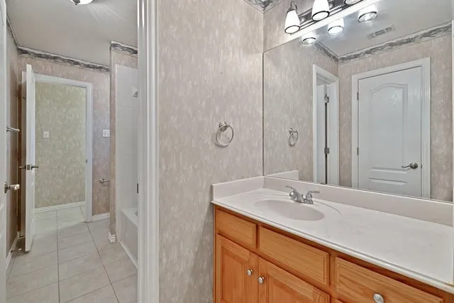a view of a livingroom with an empty space and a ceiling fan