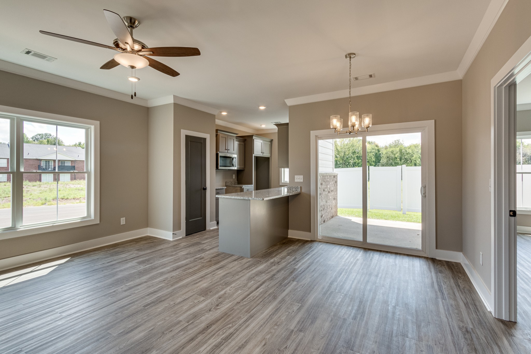 1905 Windhelm Drive Murfreesboro, TN 37129 - Photo 11 of 42 a view of an empty room with window wooden floor and a kitchen view
