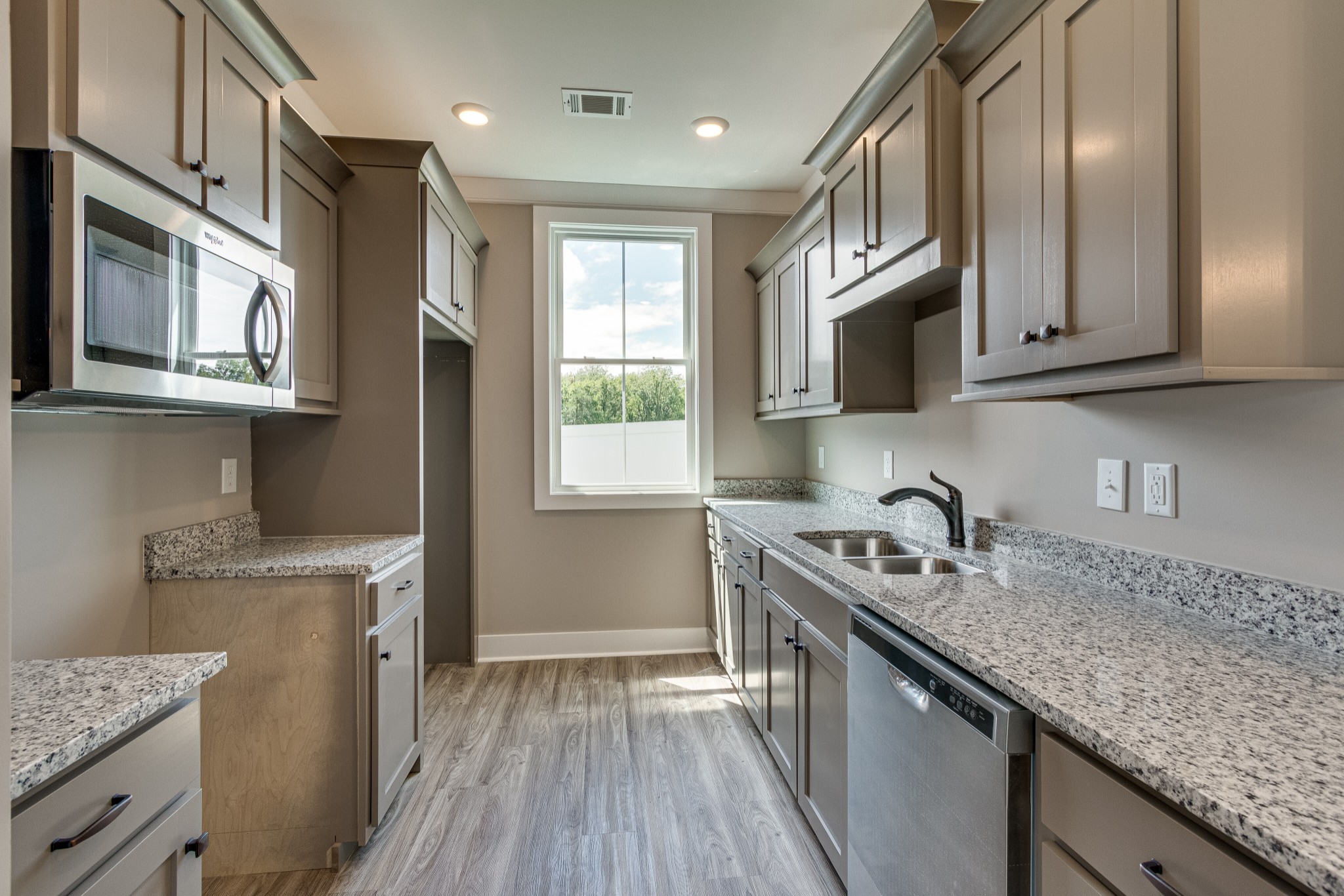 1905 Windhelm Drive Murfreesboro, TN 37129 - Photo 12 of 42 a kitchen with stainless steel appliances granite countertop a sink stove and cabinets