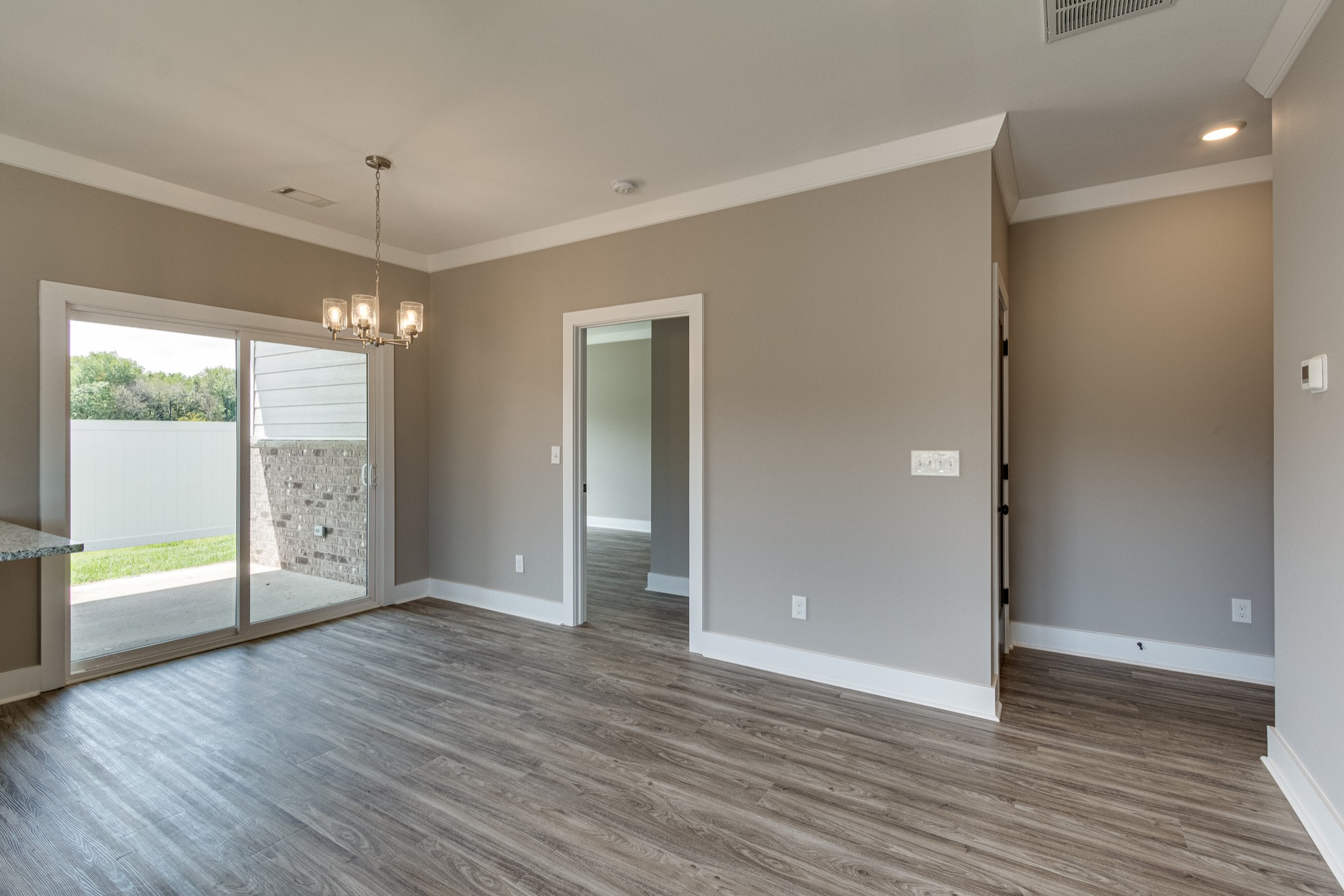 1905 Windhelm Drive Murfreesboro, TN 37129 - Photo 9 of 42 a view of an empty room with wooden floor and a window