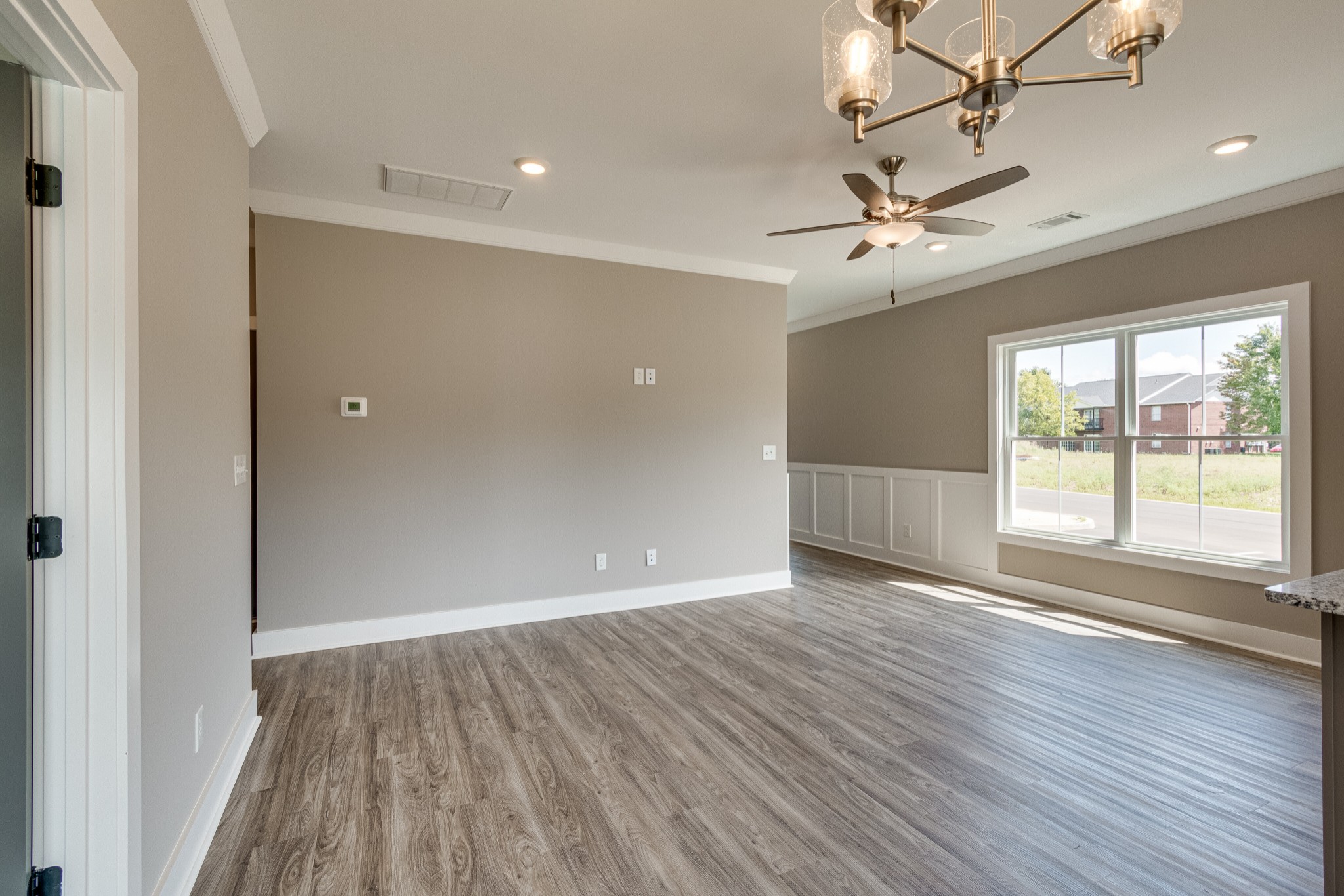 1905 Windhelm Drive Murfreesboro, TN 37129 - Photo 10 of 42 a view of an empty room with wooden floor and a window