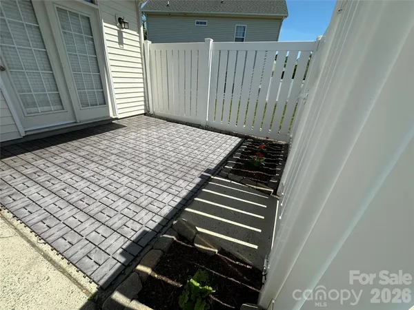 a backyard of a house with table and chairs