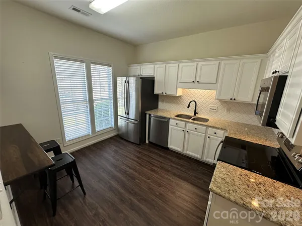 a kitchen with a sink appliances and cabinets