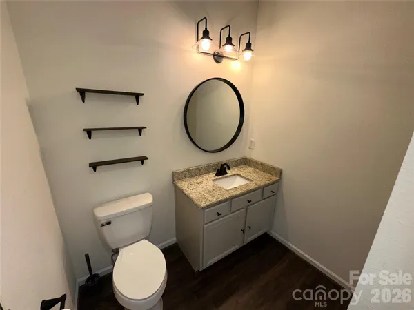a bathroom with a toilet and a mirror
