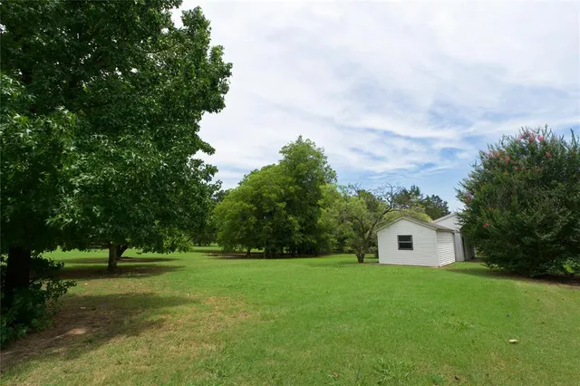 a front view of house with yard and trees