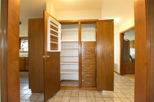 a view of walk in closet with bathroom