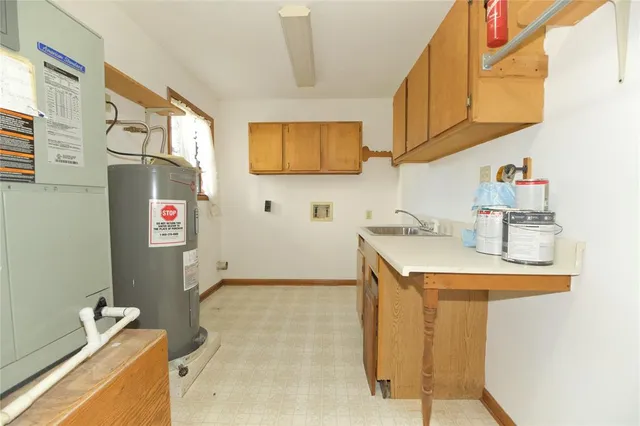 a utility room with sink dryer and washer