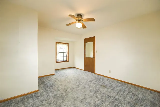 a view of a room with a floor to ceiling window and wooden floor
