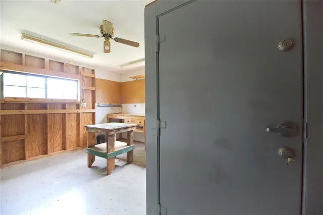 an empty room with staircase and white walls