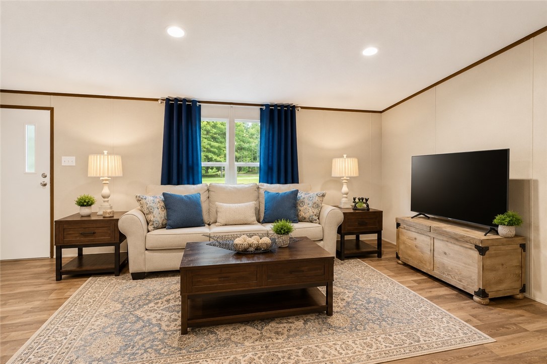 101 Drucker Ridge Anderson, SC 29625 - Photo 6 of 20 Recessed lighting illuminates this inviting living space, showcasing rich hardwood flooring and outdoor views.