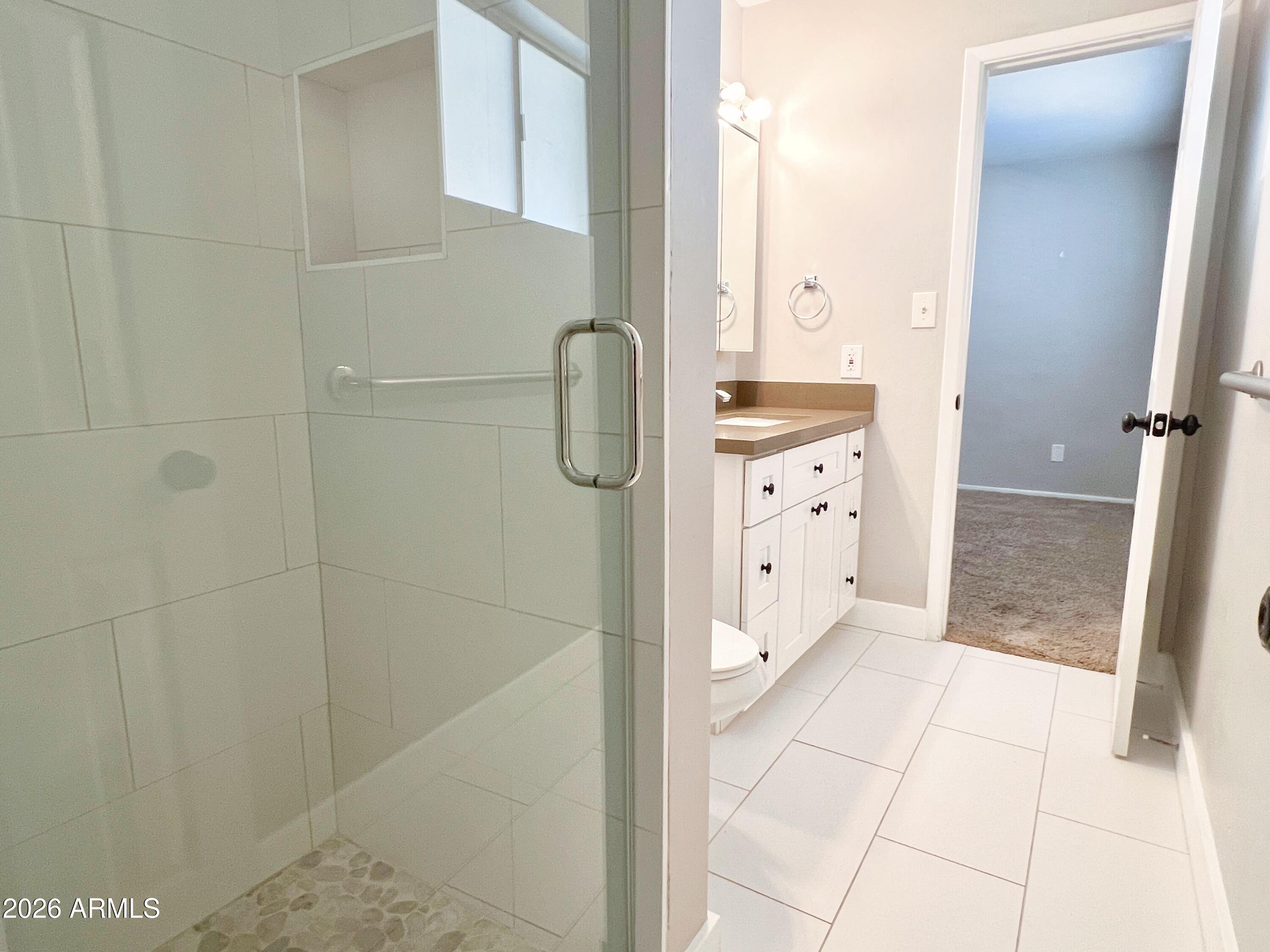 1220 West Romo Jones Street Tempe, AZ 85281 - Photo 12 of 26 a bathroom with a double vanity sink a mirror and shower