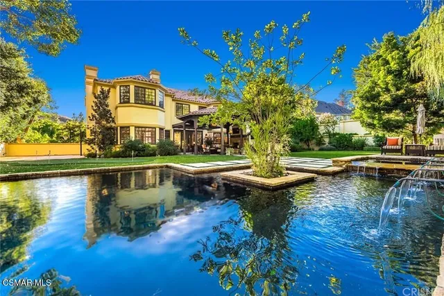 a view of swimming pool with outdoor seating and lake view