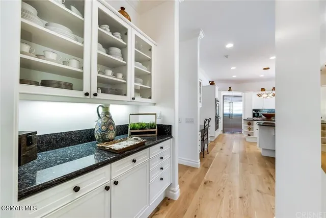 a kitchen with granite countertop a sink and cabinets