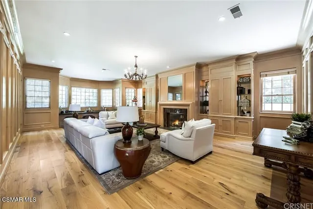 a living room with fireplace furniture and a wooden floor