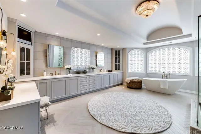 a bedroom with furniture and a large window