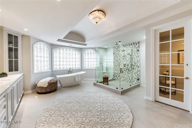 a bedroom with a bed couch and a window