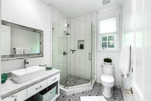 a view of a hallway with wooden floor and chandelier