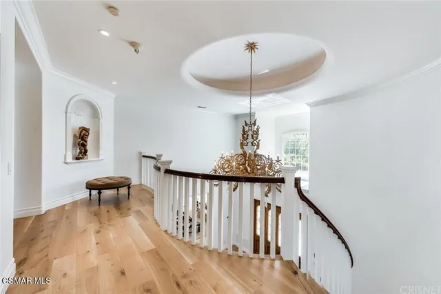 a bedroom with a bed table chair and a window