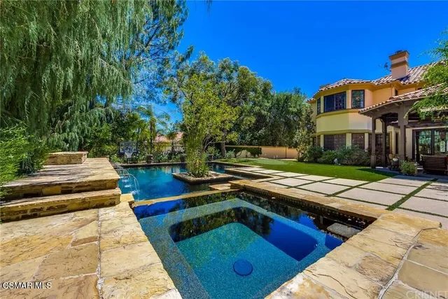 a view of a building with sitting area and garden