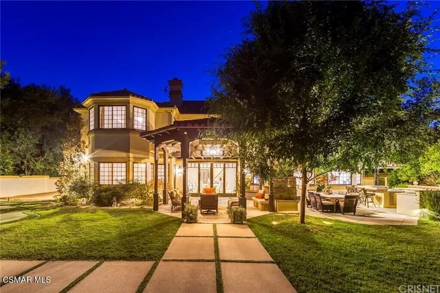 a view of a large building with a big yard and large trees