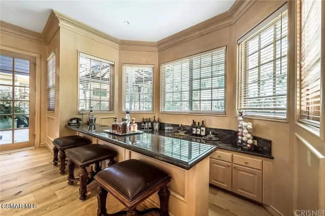 a kitchen with granite countertop a sink and a stove