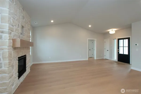 a view of an empty room with a fireplace