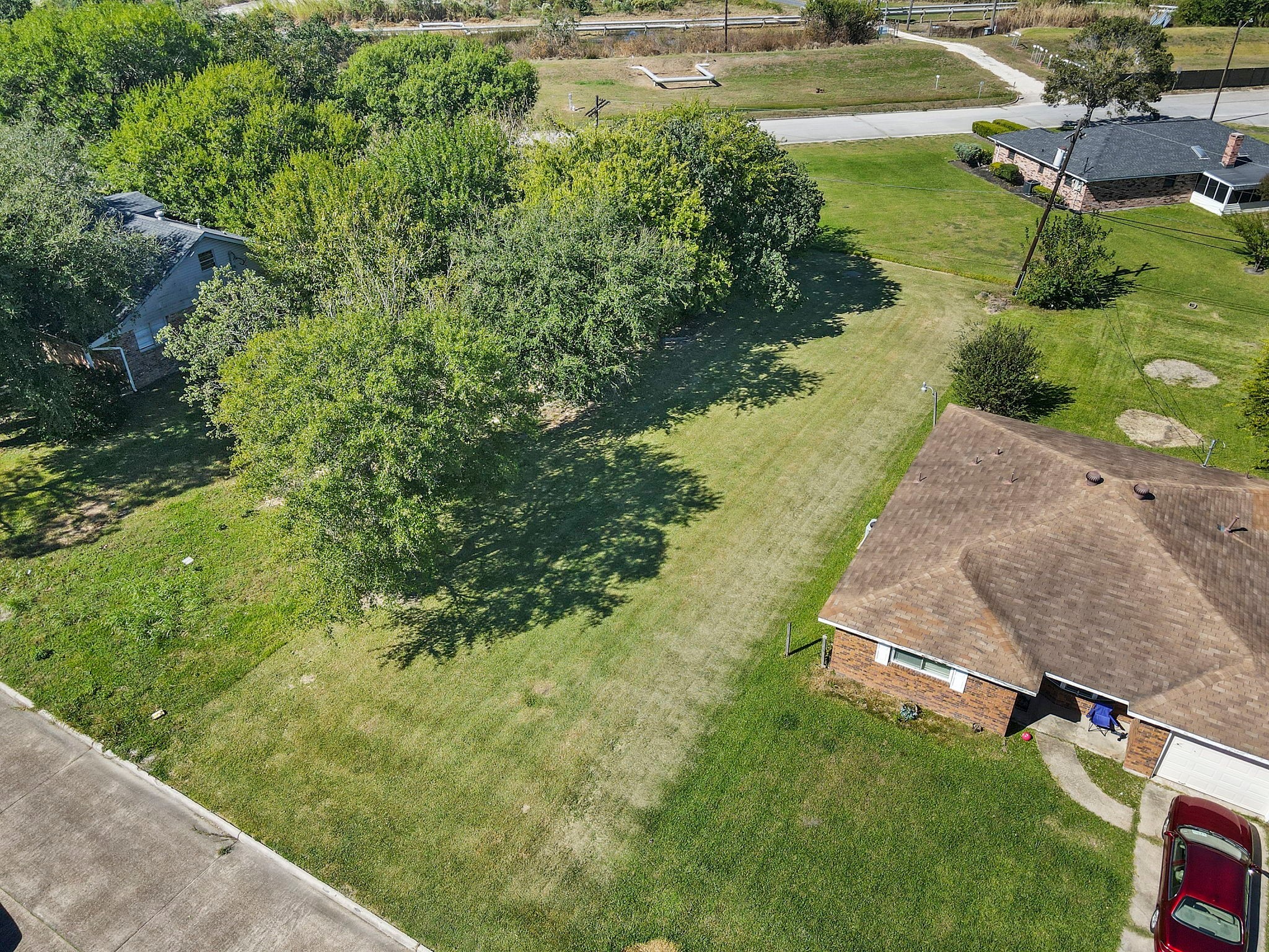 0 West 18th Street Port Arthur, TX 77640 - Photo 7 of 15 an aerial view of a house with a yard and lake view