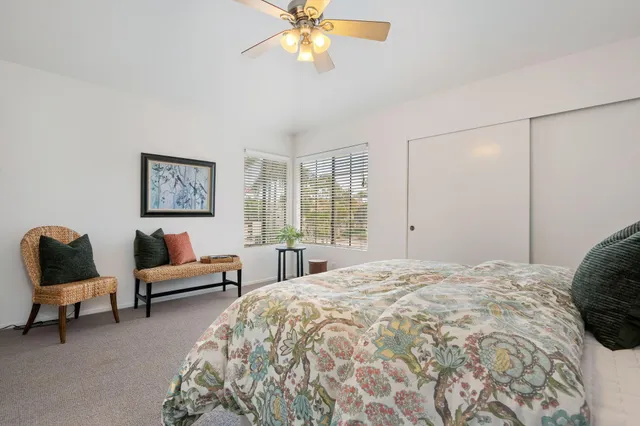 a bedroom with a bed a couch and a window