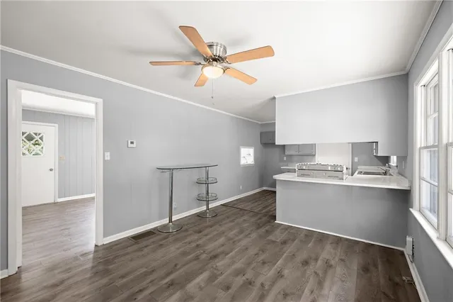 a view of kitchen with sink and wooden floor