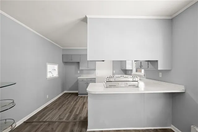 a view of kitchen with sink wooden cabinet and refrigerator