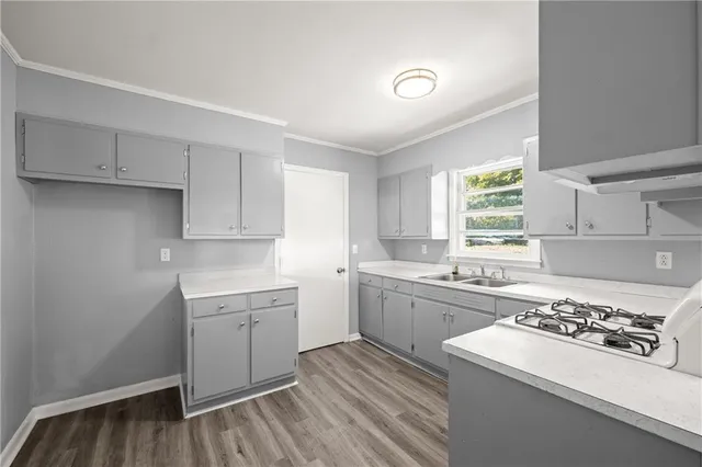 a kitchen with a sink stove and cabinets