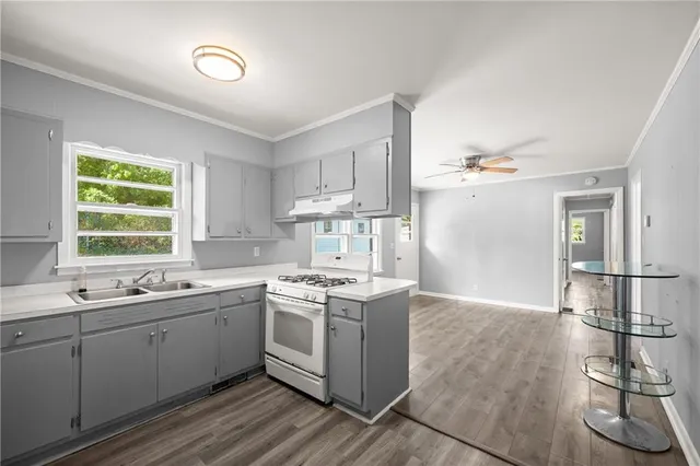 a kitchen with a sink cabinets and window