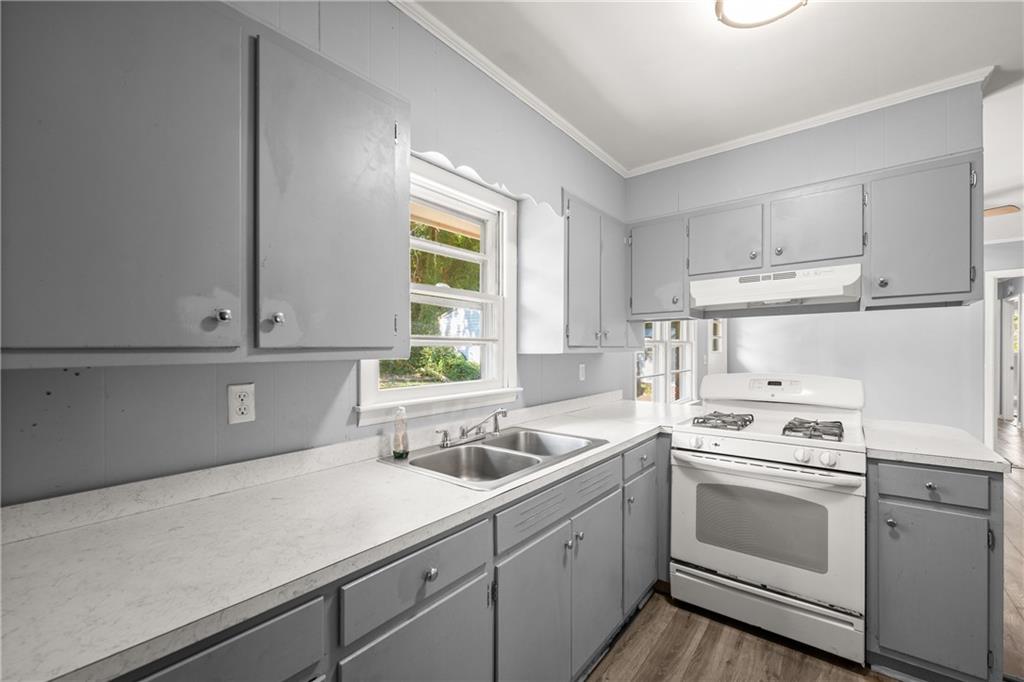 574 South Sage Street Toccoa, GA 30577 - Photo 16 of 44 a kitchen with cabinets appliances a sink and a window