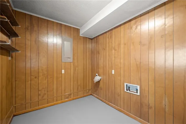 a view of an empty room with wooden walls