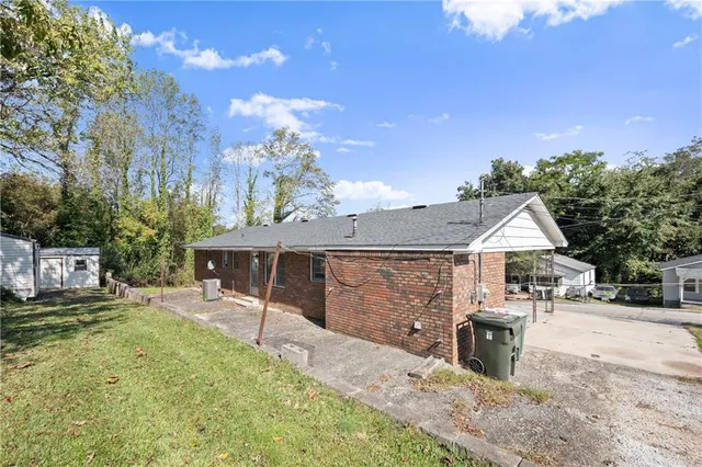 a patio with table and chairs with wooden floor and fence