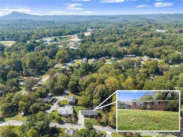 an aerial view of a house with a yard