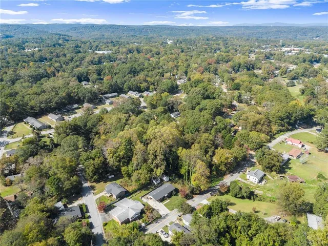 an aerial view of a houses with a yard