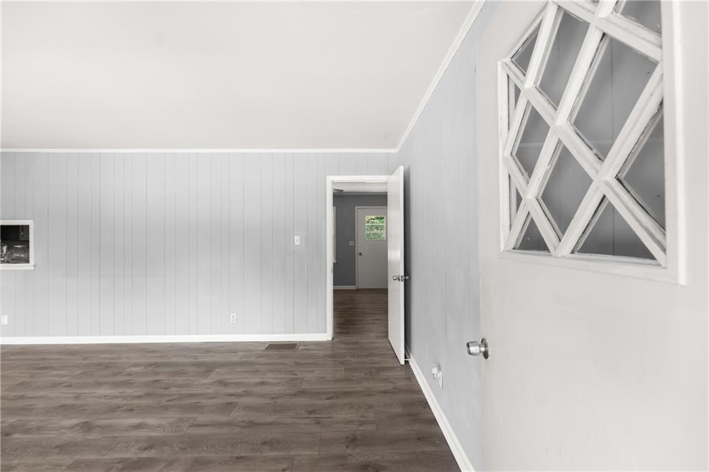 574 South Sage Street Toccoa, GA 30577 - Photo 6 of 44 a view of an empty room with wooden floor and a hallway