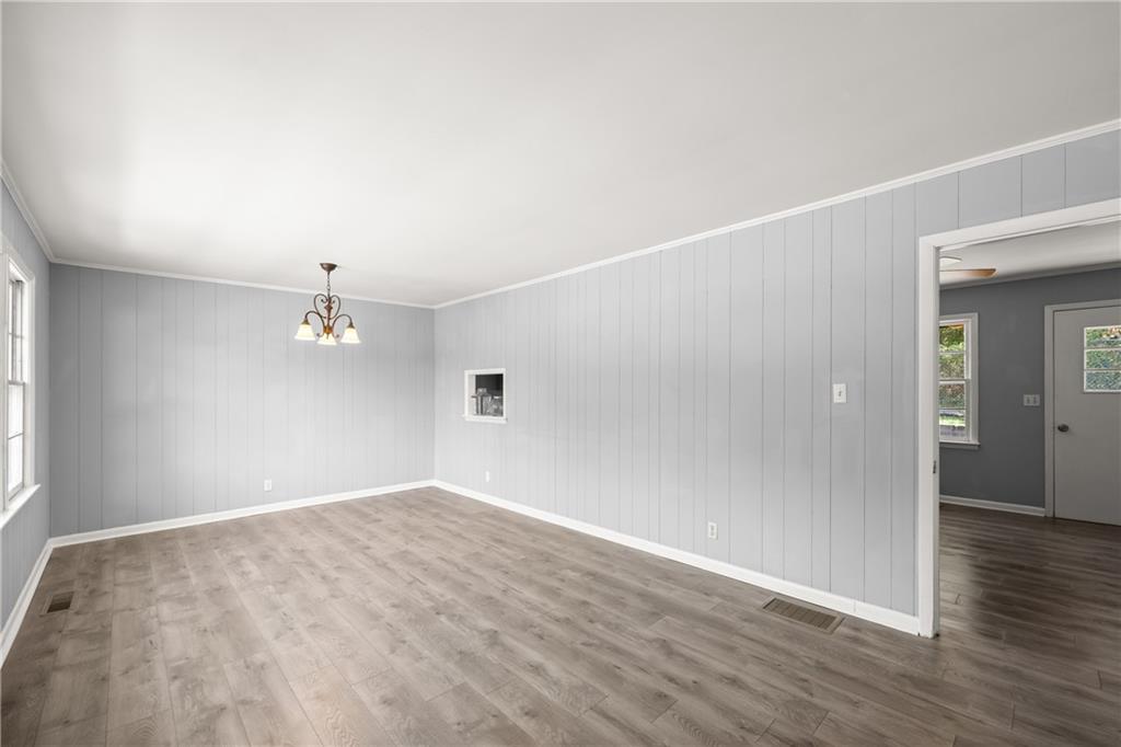 574 South Sage Street Toccoa, GA 30577 - Photo 7 of 44 an empty room with wooden floor and windows