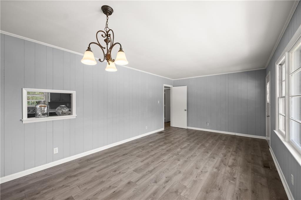 574 South Sage Street Toccoa, GA 30577 - Photo 9 of 44 a view of an empty room with wooden floor and windows