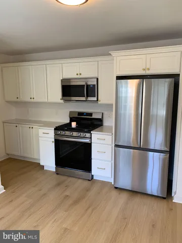 a kitchen with a refrigerator stove and microwave