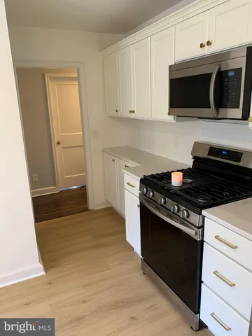a kitchen with a stove and a microwave