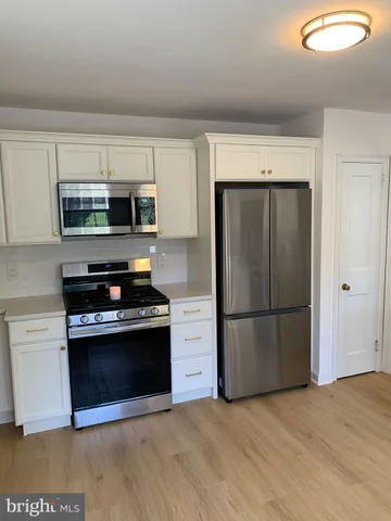 a kitchen with a refrigerator stove and microwave