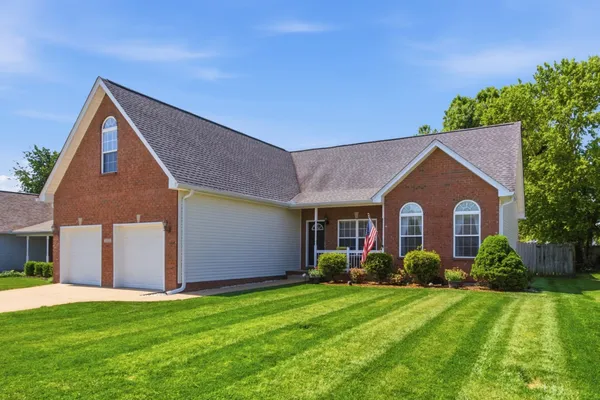 a front view of house with yard and green space