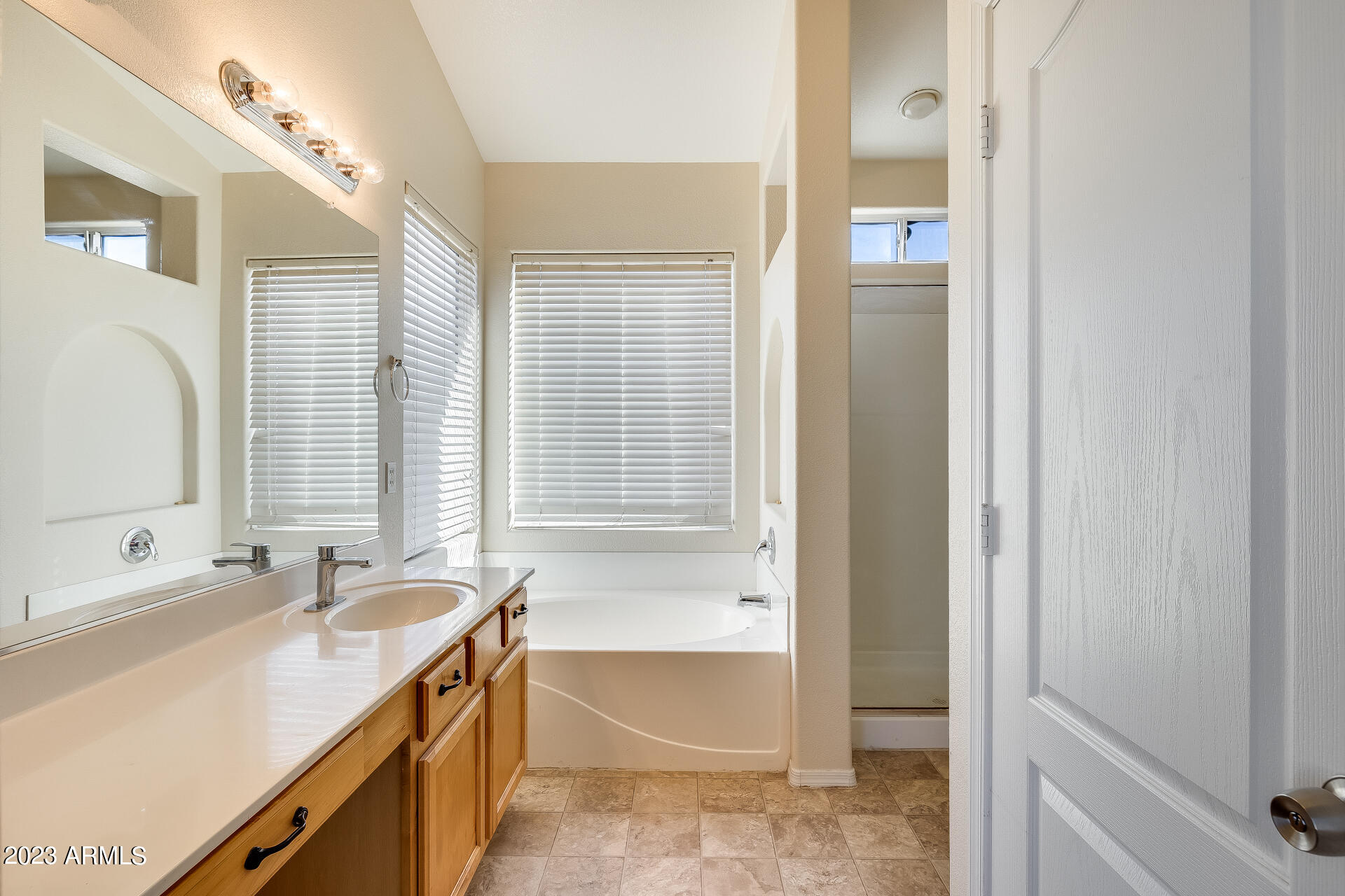 3244 West Maldonado Road Phoenix, AZ 85041 - Photo 33 of 43 a bathroom with a tub sink and mirror