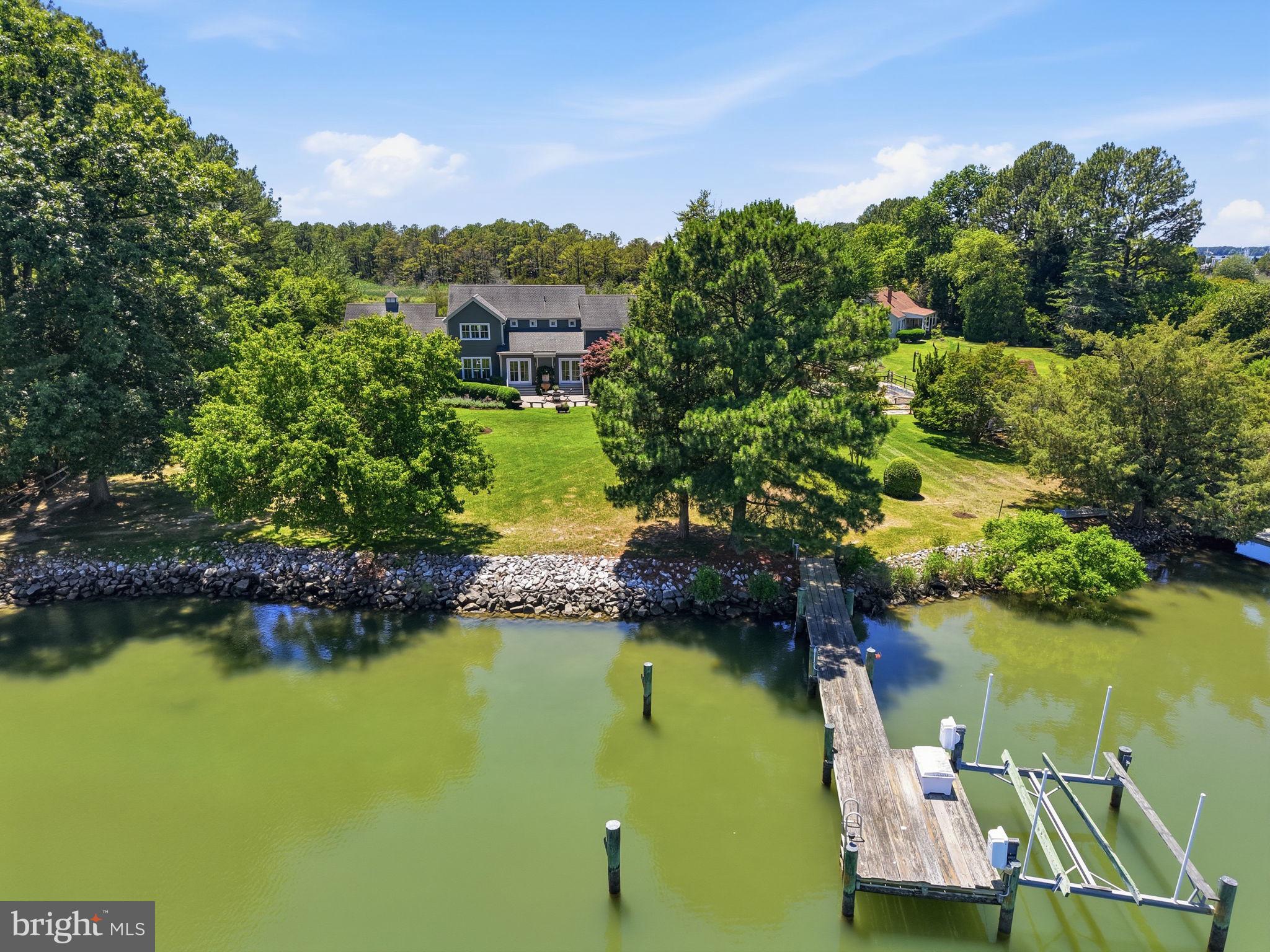 26226 Langs Landing Road Oxford, MD 21654 - Photo 2 of 48 a view of a lake with houses