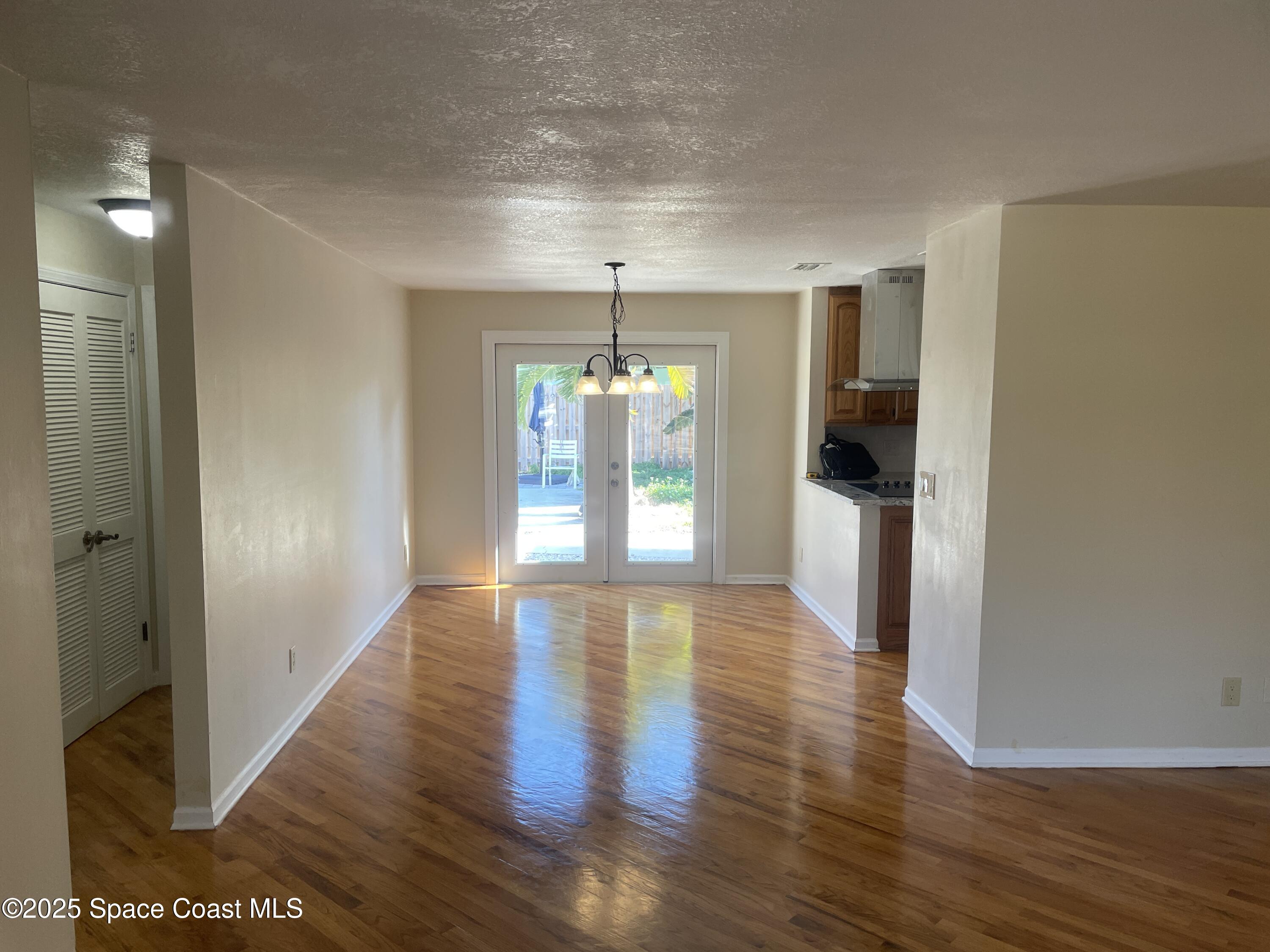 104 Jupiter Court Indialantic, FL 32903 - Photo 14 of 28 a view of a hallway with wooden floor and a living room