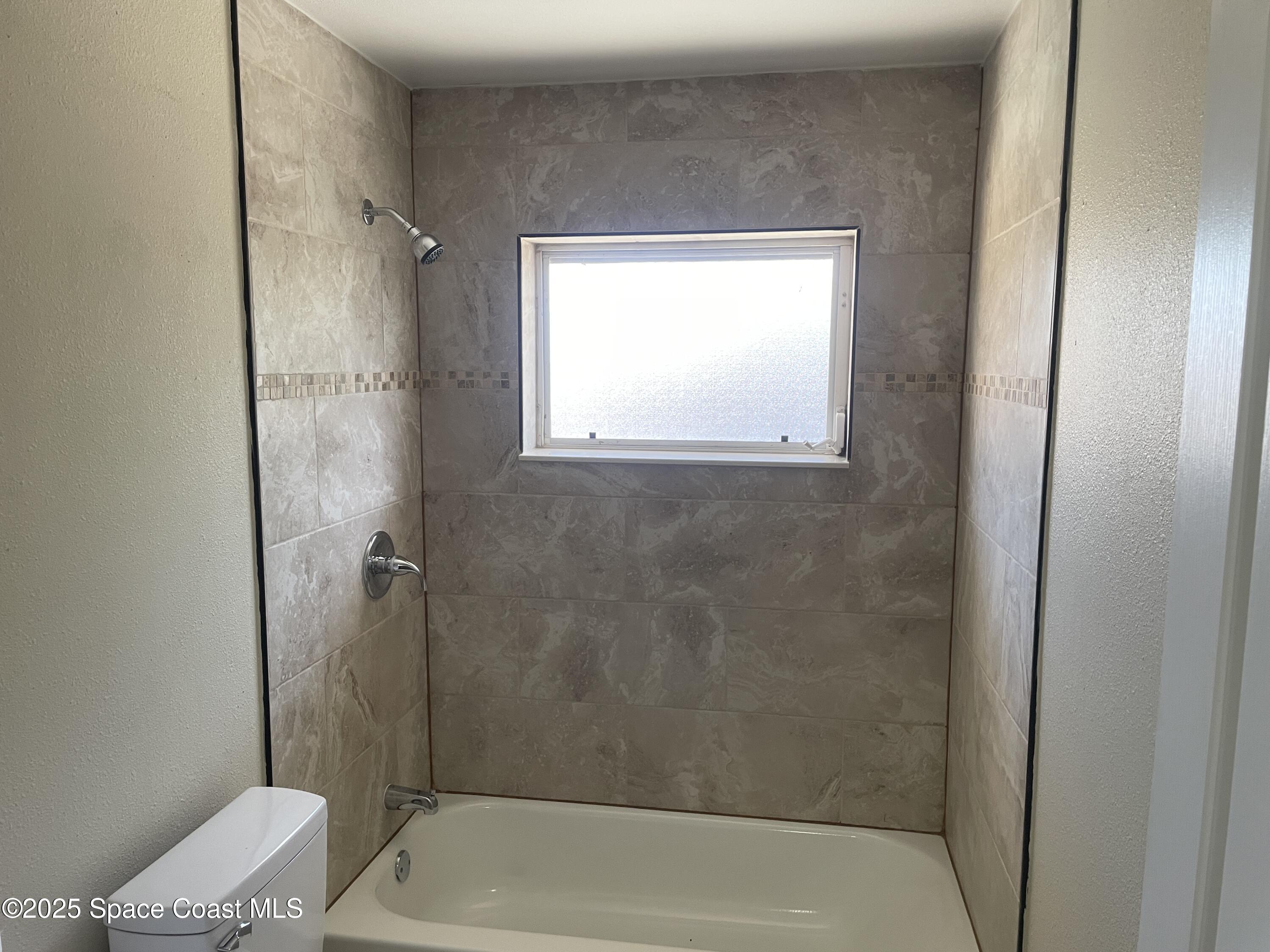 104 Jupiter Court Indialantic, FL 32903 - Photo 16 of 28 a bathroom with a bathtub and toilet