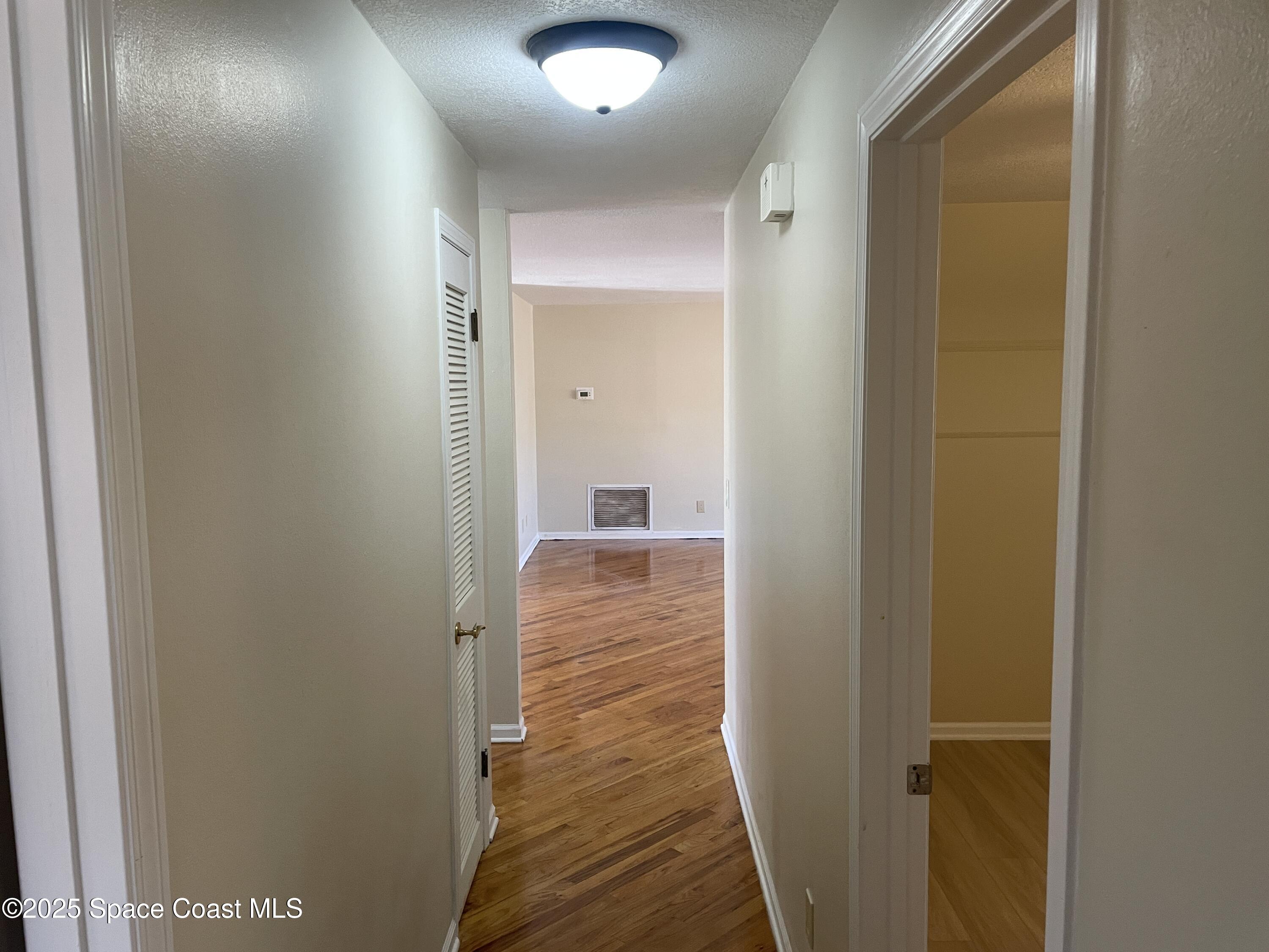 104 Jupiter Court Indialantic, FL 32903 - Photo 24 of 28 a view of a hallway with wooden floor